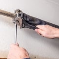 Should i replace all of the parts of my garage door when repairing it?
