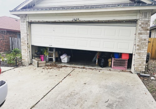 How do you reattach a garage door to track it?
